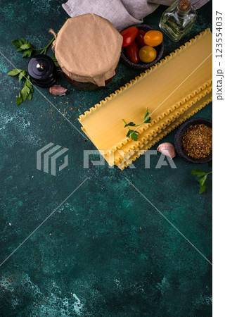 Uncooked lasagna pasta with cooking ingredient 123554037