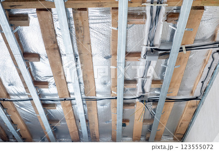 Installation of ceiling with electrical wiring. Installation of ceiling with electrical wiring. 123555072