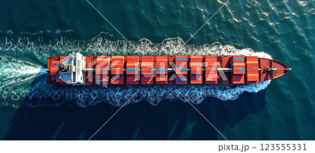 Aerial view on large commercial freighter transports a wide variety of goods on oceans around the world on sea routes 123555331