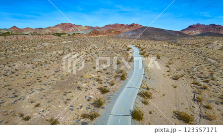 Aerial Road Through Nevada Desert to Rugged Mountains Aerial Road Through Nevada Desert to Rugged Mountains 123557171