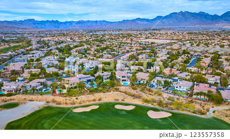 Aerial of Desert Suburb with Golf Course and Mountain Backdrop Aerial of Desert Suburb with Golf Course and Mountain Backdrop 123557358