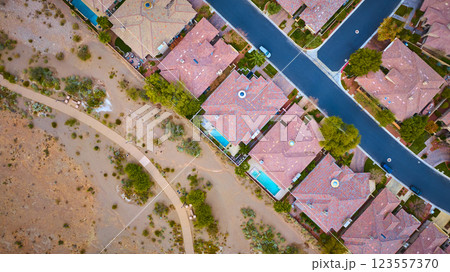 Aerial Top Down Suburban Desert Homes with Pools and Pathway in Warm Light Aerial Top Down Suburban Desert Homes with Pools and Pathway in Warm Light 123557370