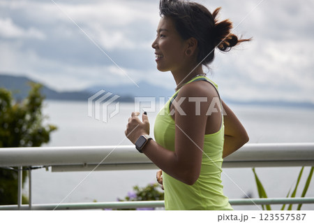 young asian woman running jogging outdoors young asian woman running jogging outdoors 123557587