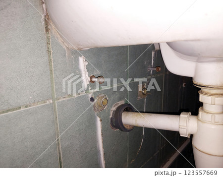 Exposed Plumbing Connections in a Bathroom Reveal Repair Work Needs Exposed Plumbing Connections in a Bathroom Reveal Repair Work Needs 123557669