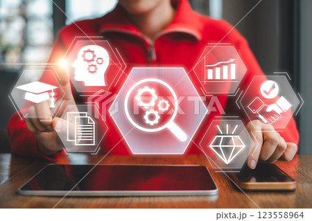 A business professional using digital tools for due diligence, analyzing data for informed decision-making in a modern office setting. 123558964