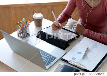young woman student is working intently using a tablet notebook 123559844