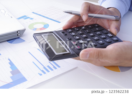 電卓でビジネスの計算をしている男性 123562238