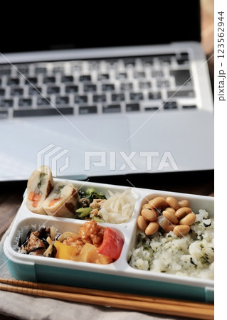 ノートパソコンと手作りのヘルシー弁当　仕事中のランチタイム 123562944