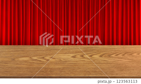 An empty wooden table is set against a red curtain background. An empty wooden table is set against a red curtain background. 123563113