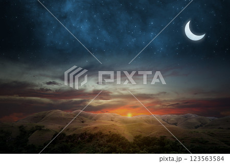 Islamic night sunset with view of landscape and crescent moon. Hilal at night with some clouds in the sky. Copy space or mockup. Concept of Eid Al Fitr and Ramadan Mubarak. Ramadan kareem background 123563584