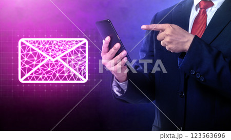 Businessman using mobile phone with a holographic email icon. Concept of business and technology 123563696