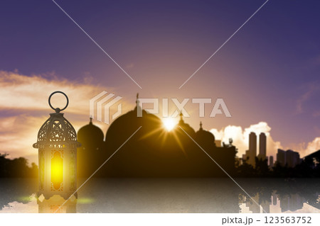 Traditional glowing Arabic lantern with a view of the silhouette of the mosque with sunlight in the sunset scene background. Concept of Religion, Spiritual or Ramadan 123563752