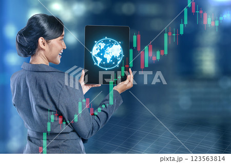 Businesswomen show global world map connection on a tablet screen with holographic economic chart, global economic trend on virtual screen. Concept of business growth, investment, or profit increase Businesswomen show global world map connection on a tablet screen with holographic economic chart, global economic trend on virtual screen. Concept of business growth, investment, or profit increase 123563814