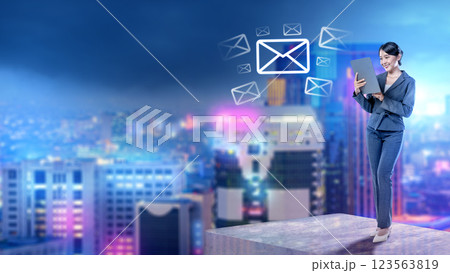 Businesswoman using tablet with email icons and modern city background. Concept of business and technology 123563819