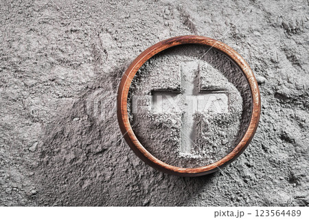 Cross imprint in gray ash bowl on ash background. Ash Wednesday Cross imprint in gray ash bowl on ash background. Ash Wednesday 123564489