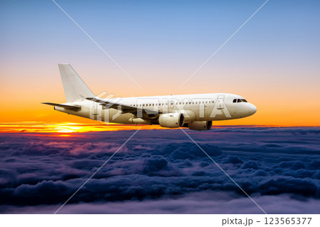White passenger airplane fly in the sunrise sky White passenger airplane fly in the sunrise sky 123565377