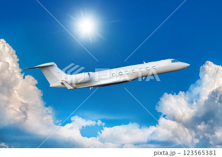 White modern luxury corporate airplane fly in the air above the clouds White modern luxury corporate airplane fly in the air above the clouds 123565381
