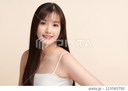 Beautiful young asian woman with clean fresh skin on beige background, Face care, Facial treatment, Cosmetology, beauty and spa, Asian women portrait. 123565792