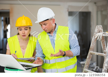 Construction workers working at house being renovated Construction workers working at house being renovated 123566358