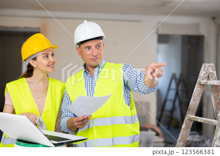 Man and woman builders talking in house 123566381