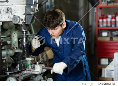 Young guy working with drill machine 123566818