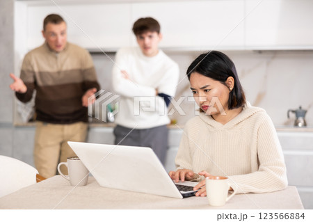 Guy and man quarrel with young woman with laptop 123566884