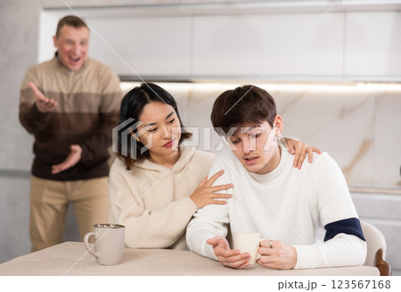Adult man quarreling with young guy and woman 123567168
