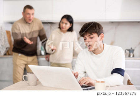 Young woman and adult man quarrel with guy with laptop 123567278