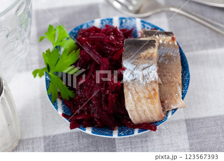 Sliced marinated herring with boiled grated beetroot and greens Sliced marinated herring with boiled grated beetroot and greens 123567393