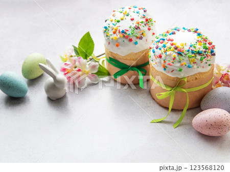 Easter cakes with colorful sprinkles, decorated eggs, and festive ornaments Easter cakes with colorful sprinkles, decorated eggs, and festive ornaments 123568120