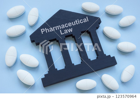Pills and the sign pharmaceutical law. Represents drug regulations concept. Pills and the sign pharmaceutical law. Represents drug regulations concept. 123570964