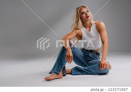 Fitness lover flaunting confidence in chic lingerie while exercising 123571007