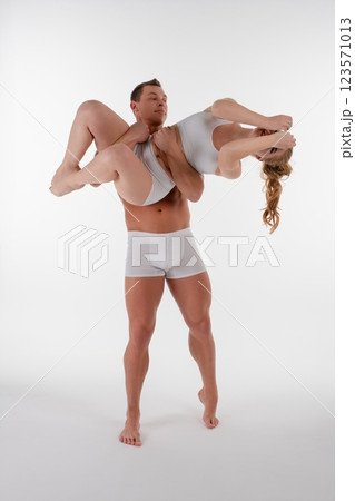 Couple engaged in dynamic sports pose showcasing strength and balance Couple engaged in dynamic sports pose showcasing strength and balance 123571013