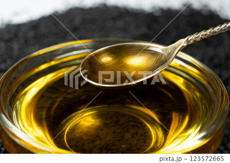 Unrefined cold pressed sesame oil in a glass bowl. Unrefined cold pressed sesame oil in a glass bowl. 123572665
