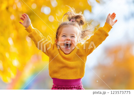 Little girl joyfully jumps in garden upon discovering a rainbow after the rain 123573775