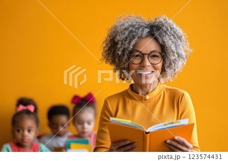 Middle aged woman teaches children reading skills at community center with warm tones 123574431