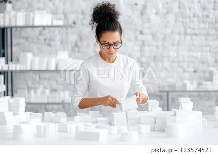 Woman sorts hygiene kits in a bright relief center focusing on organization and assistance 123574521