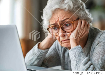 Woman with chronic fatigue struggling to focus while working at her laptop in an office setting 123574952