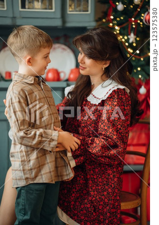 Beautiful mother and son at the Christmas tree.  123575380