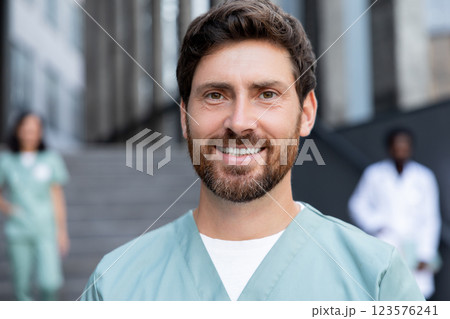 Young caucasian bearded doctor with a patient case in hands Young caucasian bearded doctor with a patient case in hands 123576241