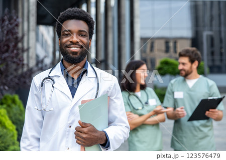 Group of doctors in lab coats looking positive and contented 123576479