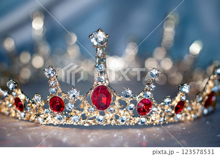 Sparkle royal golden crown with red gemstones 123578531