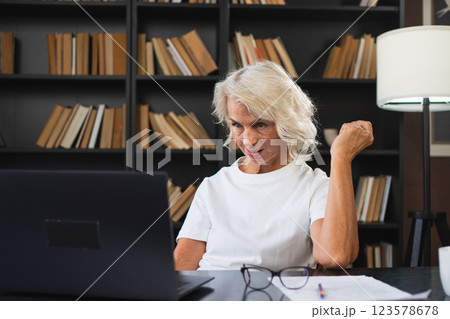 Video call. Happy middle aged senior woman sit with laptop talk on video call. Mature old senior lady having fun talking speaking online. Older generation modern tech usage Virtual meeting online chat Video call. Happy middle aged senior woman sit with laptop talk on video call. Mature old senior lady having fun talking speaking online. Older generation modern tech usage Virtual meeting online chat 123578678