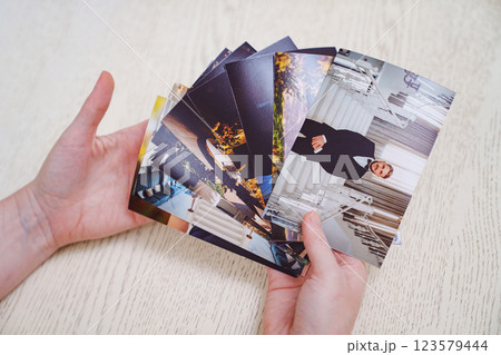hands Printed wedding photos laid out on a wooden surface. hands Printed wedding photos laid out on a wooden surface. 123579444