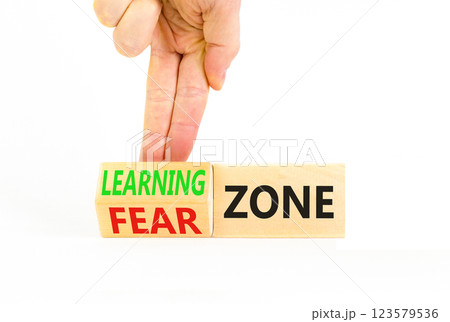 Learning or fear zone symbol. Concept words Learning zone Fear zone on wooden cubes. Beautiful white table white background. Psychologist hand. Business and learning or fear zone concept. Copy space. 123579536
