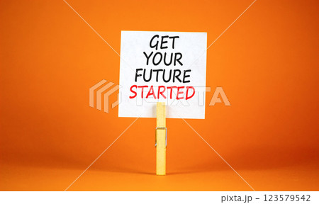 Get your future started symbol. Concept words Get your future started on beautiful white paper on clothespin. Beautiful orange background. Business get your future started concept. Copy space. 123579542