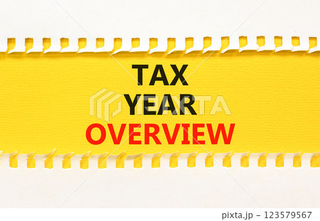 Tax year overview symbol. Concept words Tax year overview on beautiful yellow paper. Beautiful yellow white background. Business tax year overview concept. Copy space. Tax year overview symbol. Concept words Tax year overview on beautiful yellow paper. Beautiful yellow white background. Business tax year overview concept. Copy space. 123579567