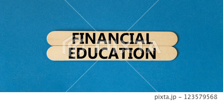 Financial education symbol. Concept words Financial education on beautiful wooden stick. Beautiful blue paper background. Business Financial education concept. Copy space. 123579568