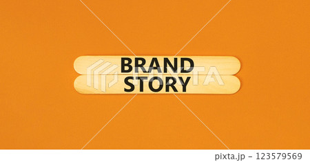 Brand story branding symbol. Concept words Brand story on beautiful wooden sticks. Beautiful orange background. Business brand story branding concept. Copy space. 123579569