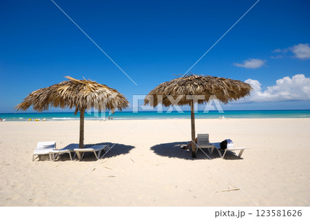 Beach with parasols and sunbeds 123581626